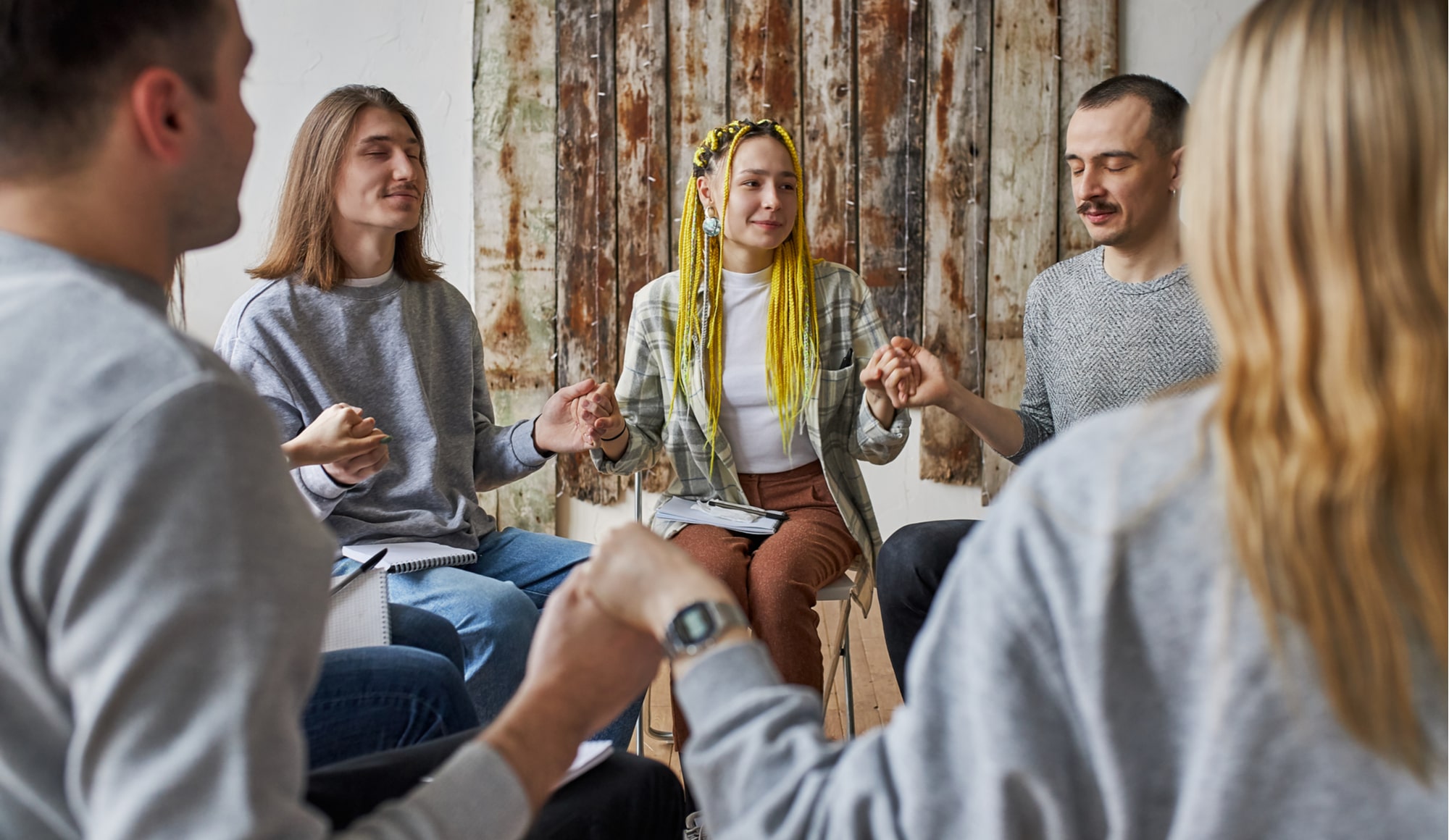 How to Tell Your Family You Need Help with Alcohol Pathfinders - A man who has been struggling with alcohol is sitting with his family and asking for help with alcohol, potentially involving going to an alcohol rehab. His family is surrounding him with love and support.
