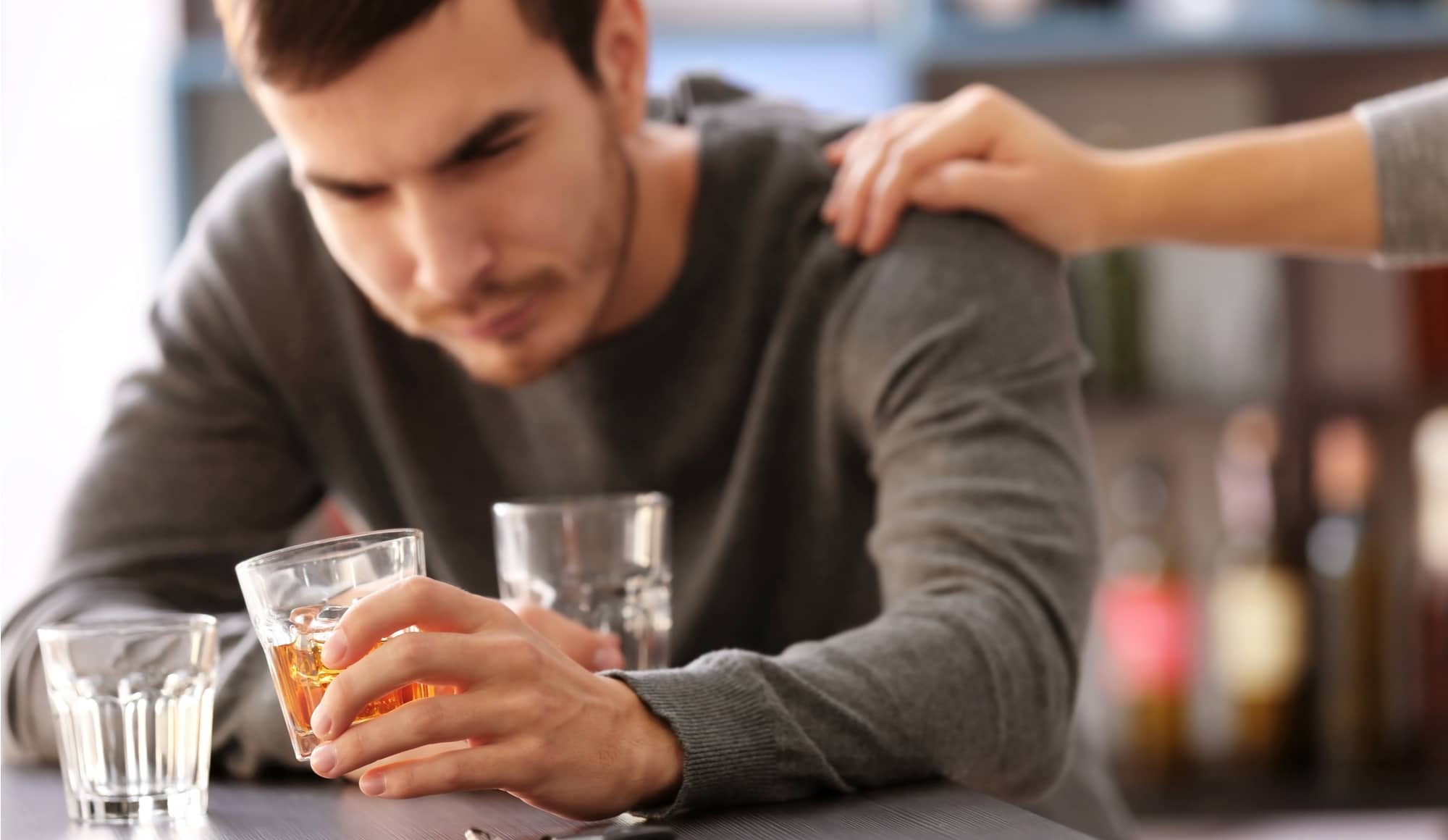 How to Tell Your Family You Need Help with Alcohol Pathfinders - A man is struggling with alcohol abuse and is determining how to tell his family that he may need an alcohol rehab or other form of rehabilitation treatment to overcome his substance abuse issues with alcohol.