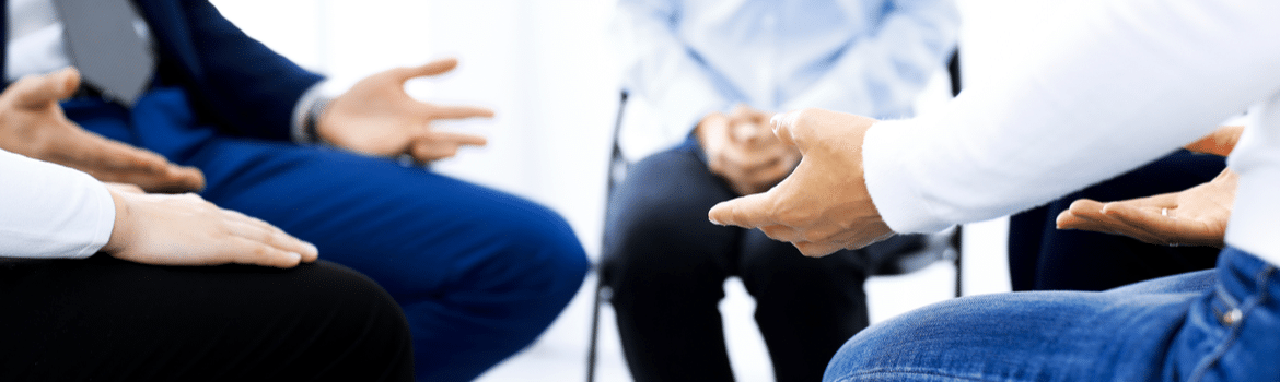 Long-Term Rehab for Alcoholism for Long-Lasting Sobriety - Pathfinders - Individuals attending a long-term rehab for alcoholism are participating in a group therapy session.