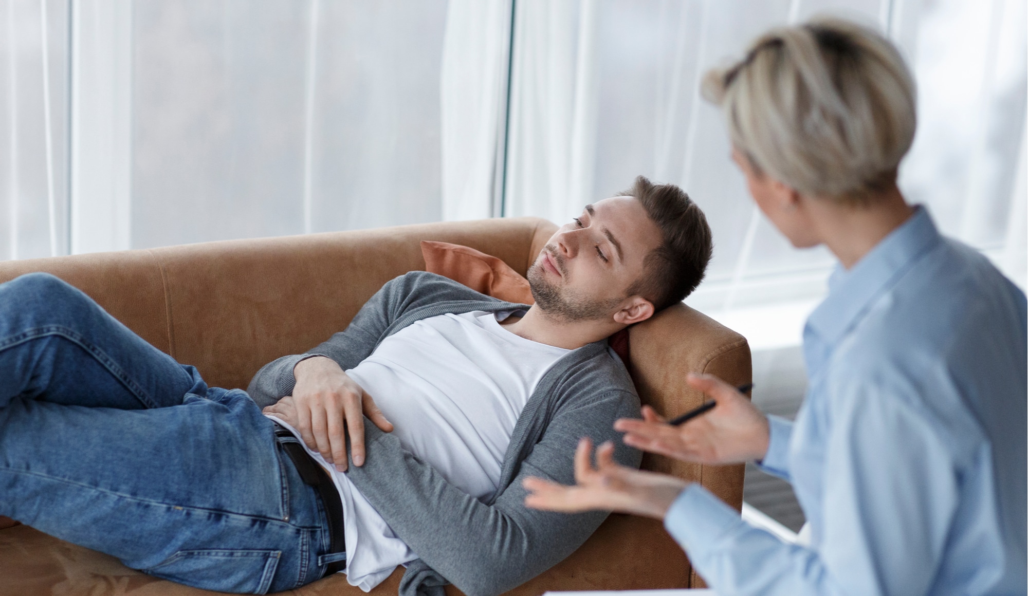 What are Some Common Signs of a Drug Addict? Pathfinders Recovery Center - A young man is sitting with an addiction specialist for an initial consultation to determine if he has the signs of a drug addict and if he requires treatment.