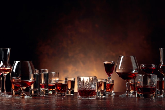 Most Addictive Drugs - Photo of several alcoholic drinks in glasses of all sizes and types. Alcohol is one of the most addictive drugs. 